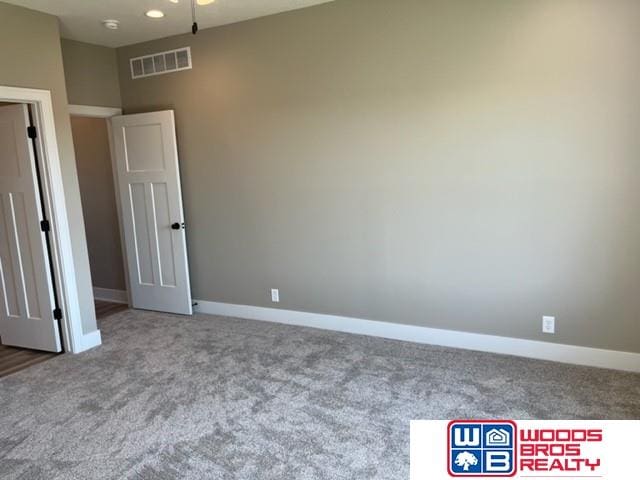 1127 Asher Ave, Hickman, NE 68372 - unfurnished room featuring carpet flooring and baseboards
