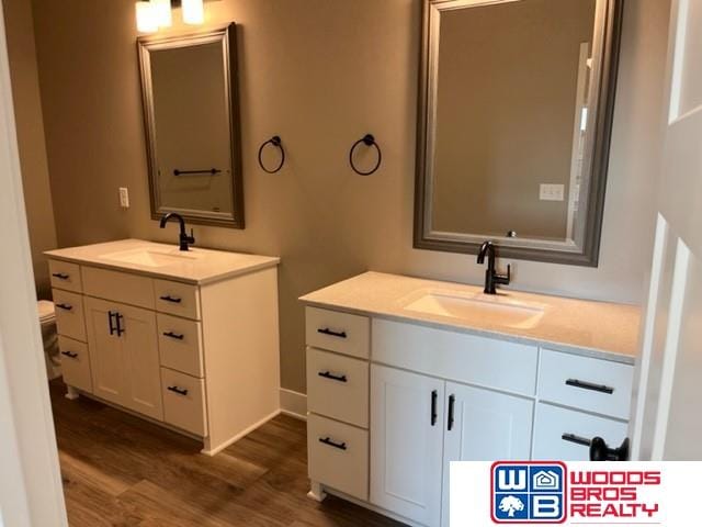 bathroom with vanity, hardwood / wood-style floors, and toilet