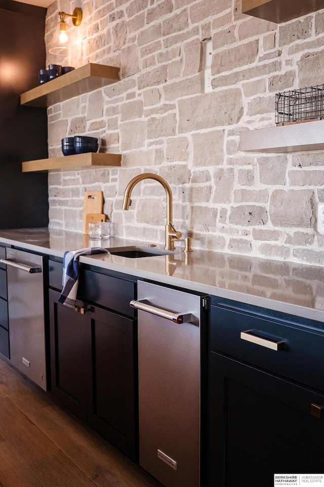 kitchen with stainless steel dishwasher and dark wood-type flooring