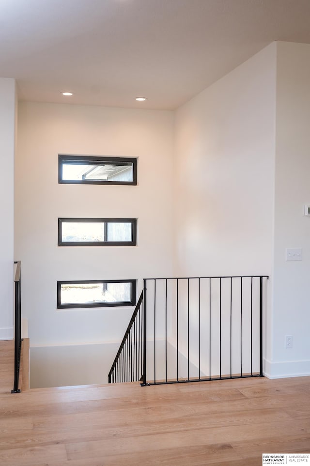 stairs with hardwood / wood-style floors and a wealth of natural light