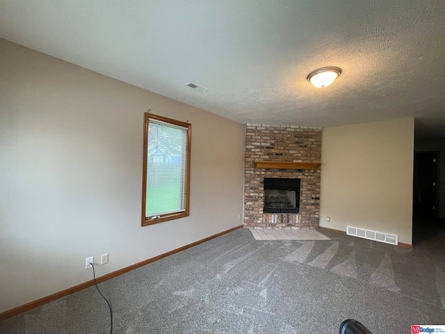 unfurnished living room with carpet flooring, a textured ceiling, and a fireplace