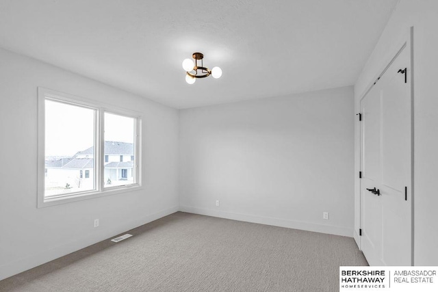 unfurnished room with light colored carpet