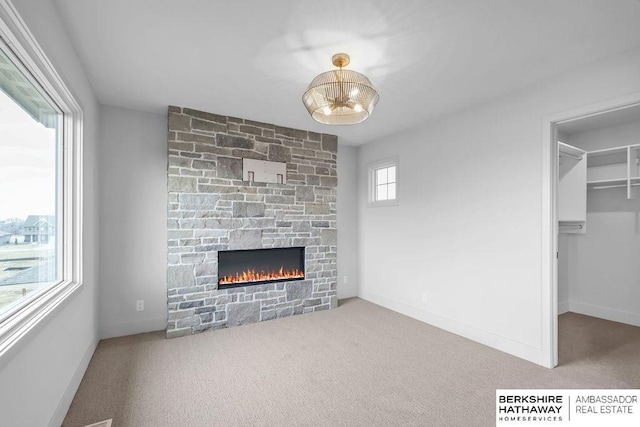 unfurnished living room featuring carpet floors and a fireplace