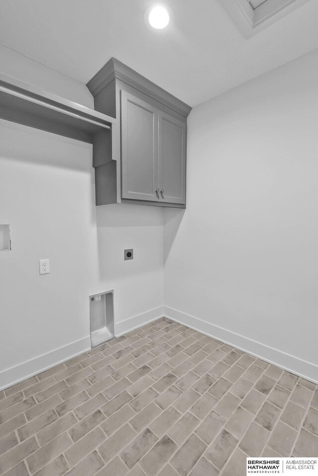 washroom featuring hookup for an electric dryer and cabinets