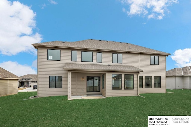 rear view of house with a yard and a patio