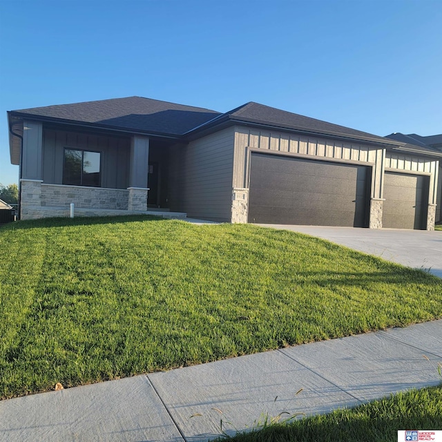 prairie-style house with a front yard and a garage