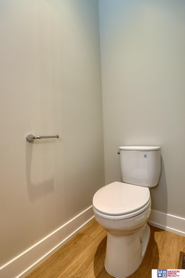 bathroom featuring toilet and hardwood / wood-style flooring