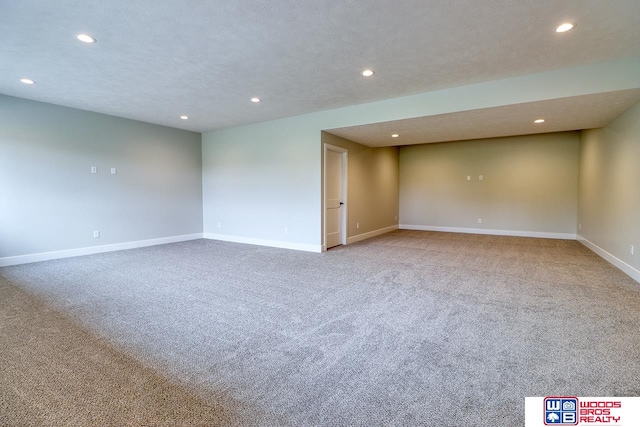 carpeted spare room featuring a textured ceiling