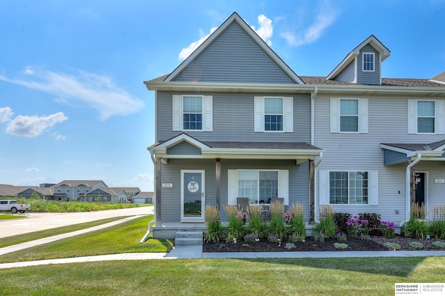 view of front of property featuring a front lawn and covered porch