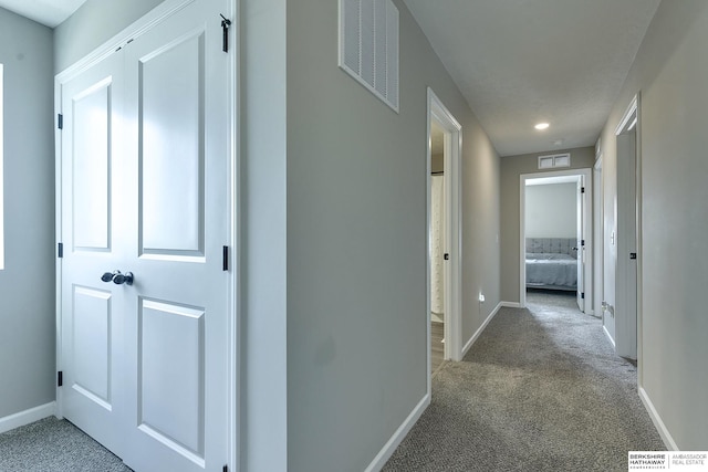 hallway with carpet floors