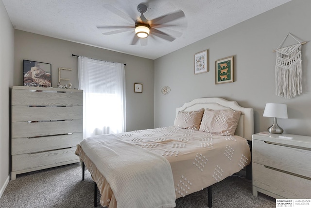 carpeted bedroom featuring ceiling fan and a textured ceiling