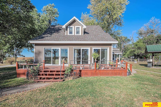 back of house featuring a wooden deck and a lawn