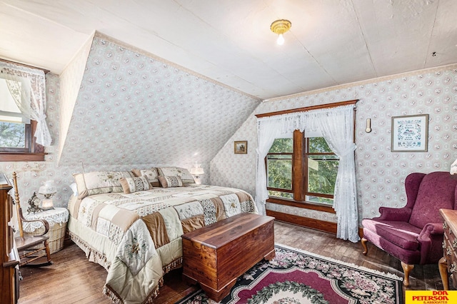 bedroom with lofted ceiling and light hardwood / wood-style floors