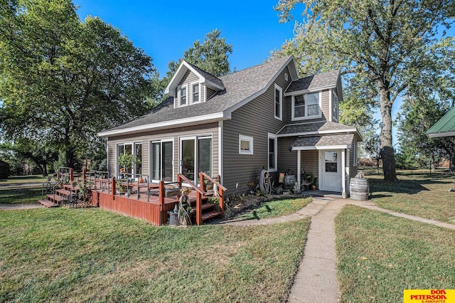 back of property featuring a wooden deck and a lawn