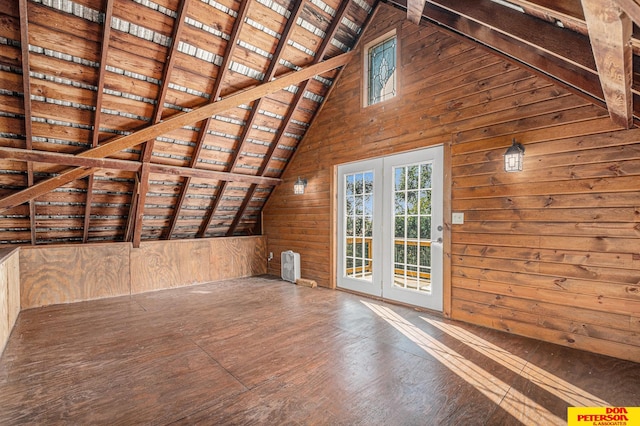 interior space with hardwood / wood-style flooring, vaulted ceiling with beams, wooden ceiling, and wood walls