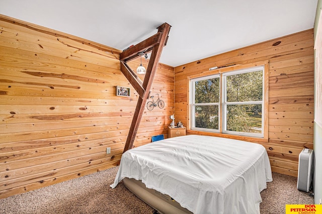 bedroom featuring wooden walls and carpet