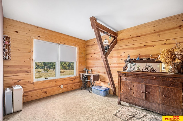 interior space featuring wood walls and light colored carpet