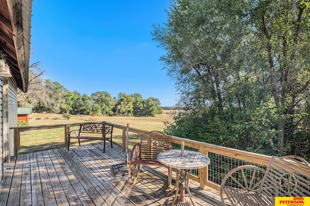 wooden deck featuring a rural view