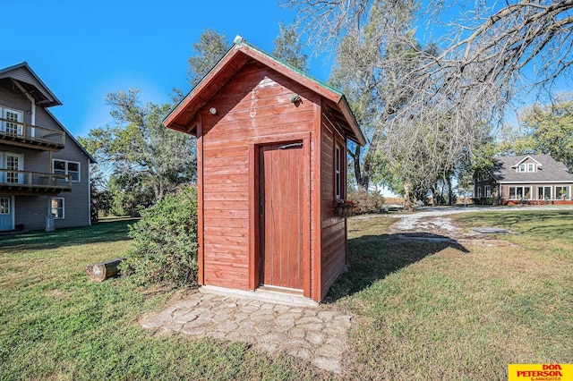 view of outbuilding featuring a yard