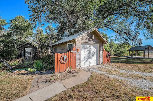 view of outbuilding featuring a lawn, a gazebo, and a garage