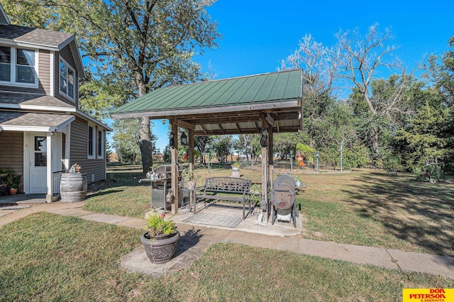 view of property's community with a lawn and a gazebo