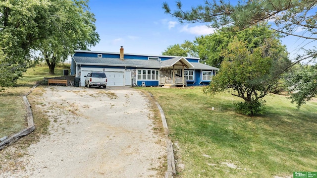 ranch-style house featuring a front yard, a garage, and covered porch