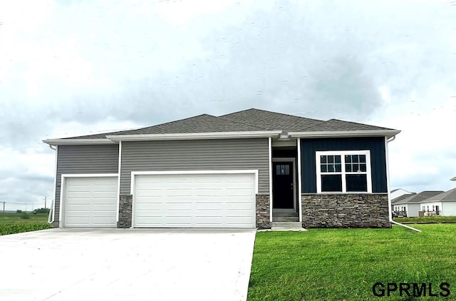 view of front of home featuring a garage and a front lawn