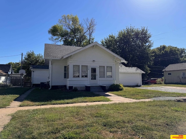 bungalow-style house featuring a front yard