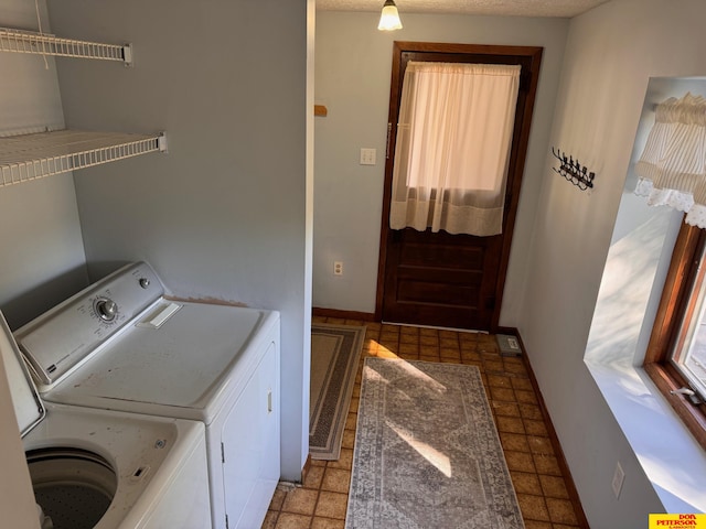 clothes washing area with washing machine and clothes dryer