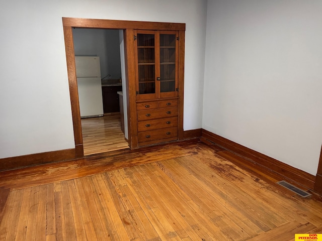 spare room with wood-type flooring