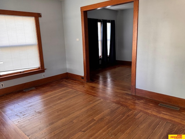 spare room featuring dark hardwood / wood-style floors