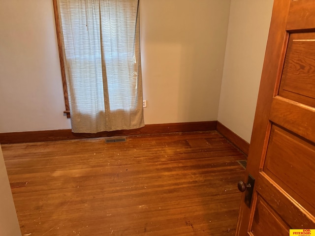 unfurnished room featuring dark hardwood / wood-style flooring