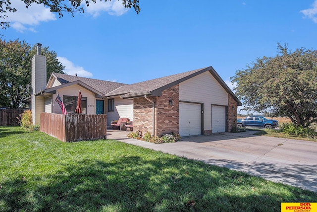 view of front facade with a front yard and a garage