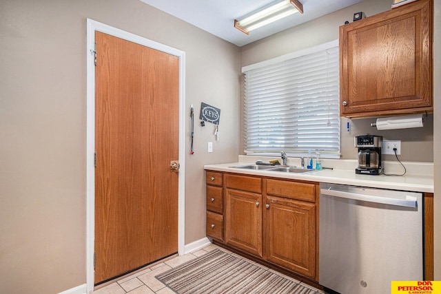 kitchen featuring light tile patterned floors, dishwasher, and sink