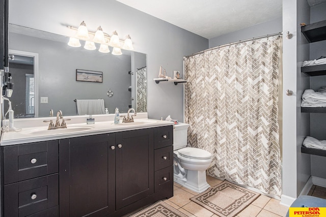 bathroom featuring tile patterned flooring, vanity, and toilet