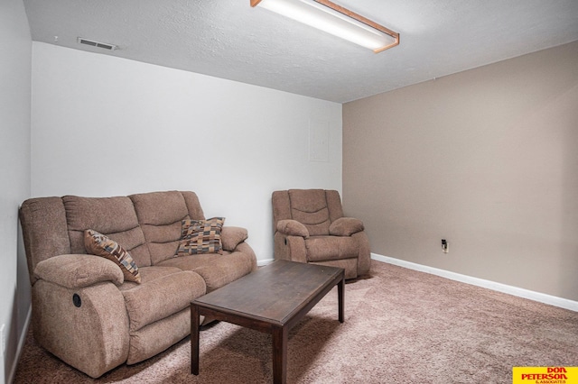 carpeted living room featuring a textured ceiling