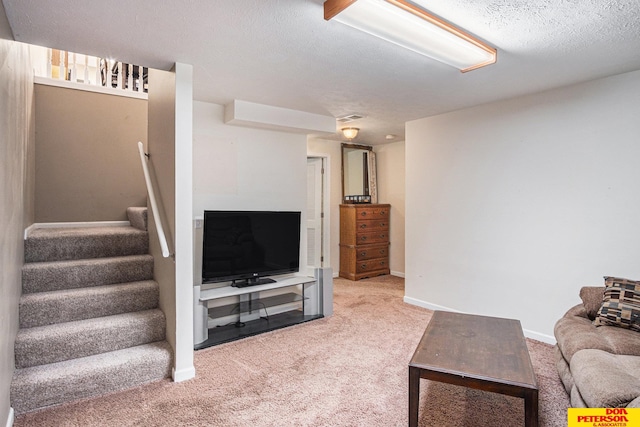 carpeted living room with a textured ceiling