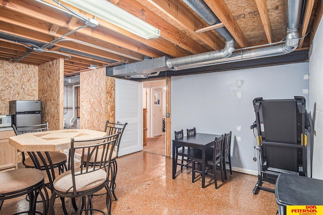 basement featuring stainless steel refrigerator