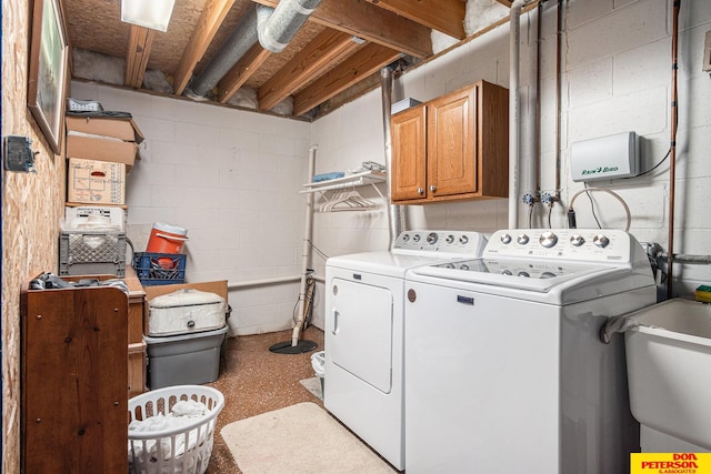 laundry room featuring washer and clothes dryer, cabinets, and sink