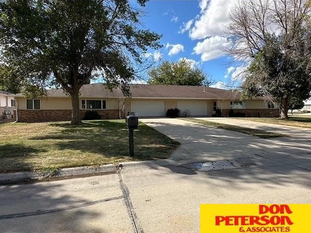 single story home featuring a front lawn and a garage