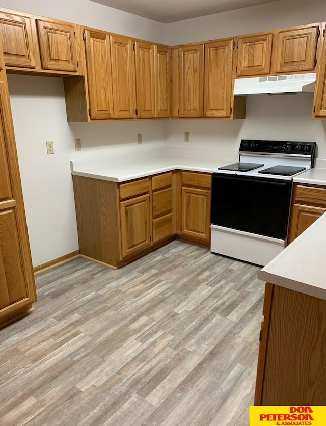 kitchen with white electric stove and light wood-type flooring