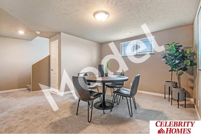 dining space featuring a textured ceiling and carpet