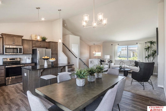 dining room with dark hardwood / wood-style flooring, an inviting chandelier, and high vaulted ceiling