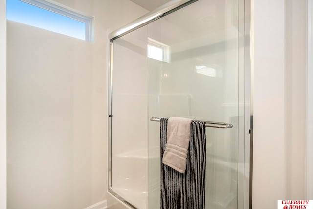 bathroom with a wealth of natural light and walk in shower