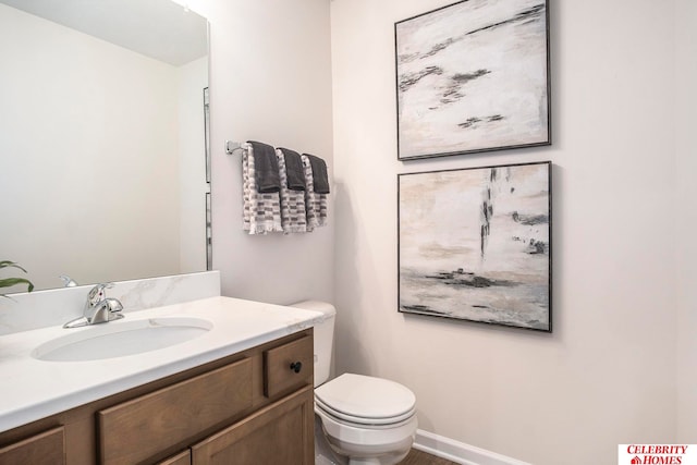 bathroom featuring vanity and toilet