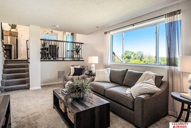 living room featuring carpet and a textured ceiling