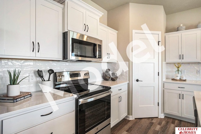 kitchen featuring dark wood-style floors, light countertops, decorative backsplash, appliances with stainless steel finishes, and white cabinetry