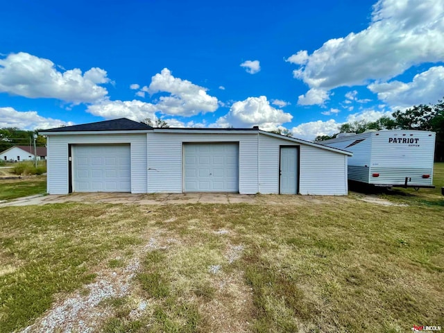 garage featuring a yard