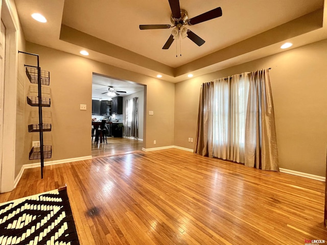 3800 SW 16th St, Lincoln, NE 68522 - empty room with a ceiling fan, recessed lighting, a raised ceiling, baseboards, and hardwood / wood-style flooring