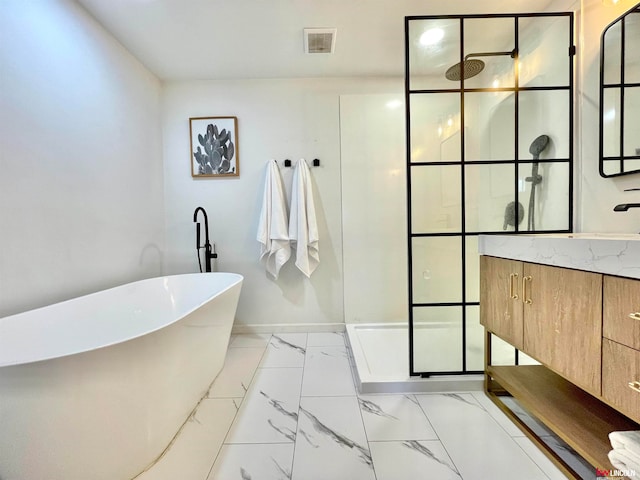 bathroom featuring vanity and separate shower and tub